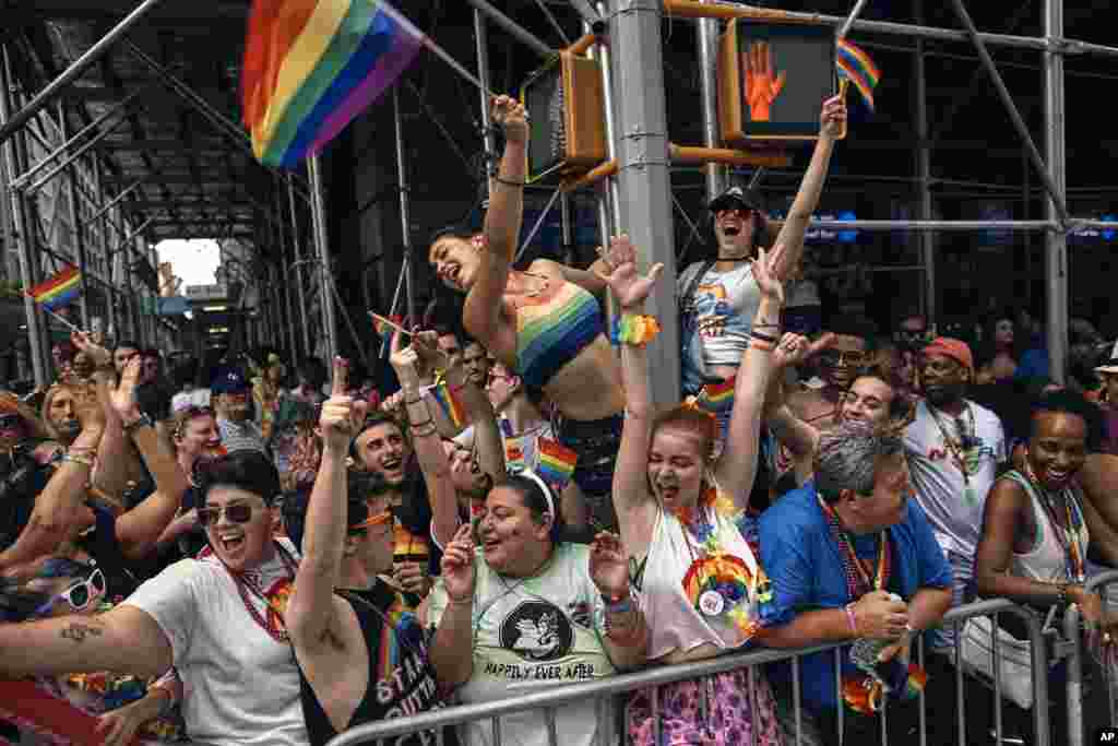 People cheer as floats travel along Fifth Avenue during the New York City Pride Parade, June 25, 2017.