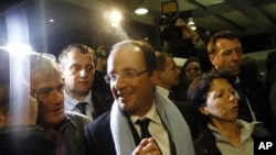 Socialist candidate Francois Hollande, center, arrives at Brive airport in Brive, Central France, after the first round of the presidential election, April 22, 2012. 