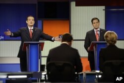 Ted Cruz makes a point as Marco Rubio listens during a Republican presidential primary debate in Des Moines, Iowa, Jan. 28, 2016.