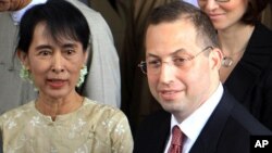 Pro-democracy leader Aung San Suu Kyi, left, sees off Derek Mitchell, right, Washington's special representative to Burma, after their meeting at her home in Rangoon, Sept ember 12, 2011.