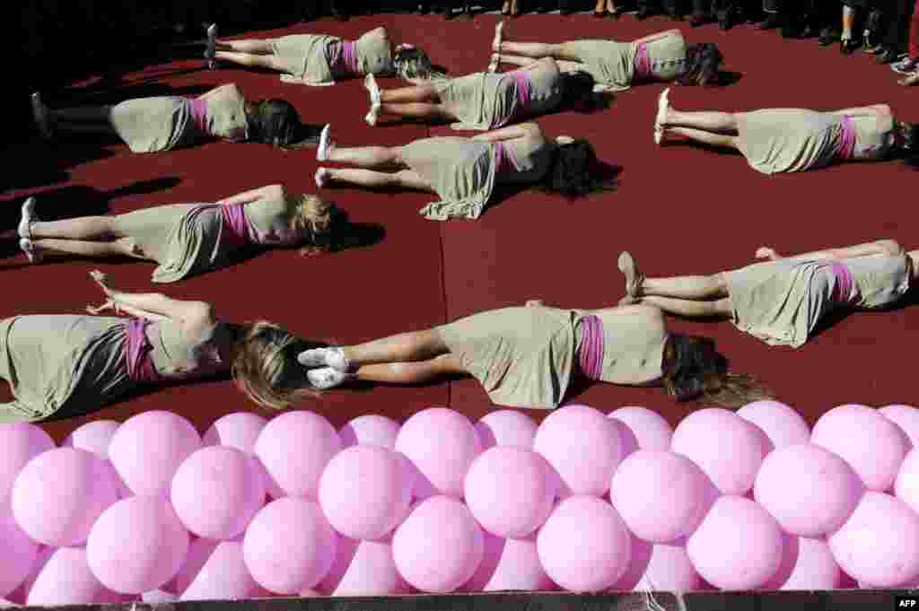 Members of Kosovo ballet perform during an event to raise awareness on breast cancer in Pristina. 