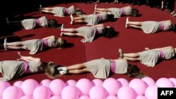 Members of Kosovo ballet perform during an event to raise awareness on breast cancer in Pristina. 