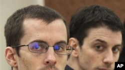 A picture released by Iran's state-run Press TV shows US hikers Shane Bauer (L) and Josh Fattal (R), detained in Iran on spying charges, during the first session of their trial, February 6, 2011.