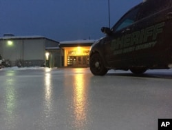 In this image provided by the Hood River County sheriff, lights from a school reflect off the ice-coated parking lot in Hood River, Ore., Jan. 18, 2017.