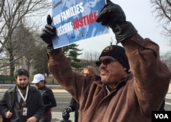 About 50 immigrants protested outside the Supreme Court, urging the justices to take up a case involving President Obama's executive order on immigration. (Carolyn Presutti/VOA)