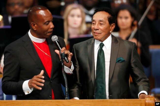 Bishop Charles H. Ellis, III, pastor of Greater Grace Temple (L) talks with Smokey Robinson during the funeral service for Aretha Franklin at Greater Grace Temple, Aug. 31, 2018, in Detroit.