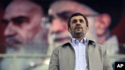In front of portraits of the late Iranian revolutionary founder Ayatollah Khomeini (L) and supreme leader Ayatollah Ali Khamenei, President Mahmoud Ahmadinejad joins a ceremony commemorating International Day Against Drug Abuse, at the Azadi [Freedom] spo