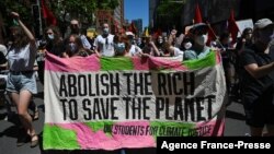 People participate in a rally during a global day of action on climate change in Sydney on Nov. 6, 2021, as world leaders attend the COP26 UN Climate Change Conference in Glasgow. 