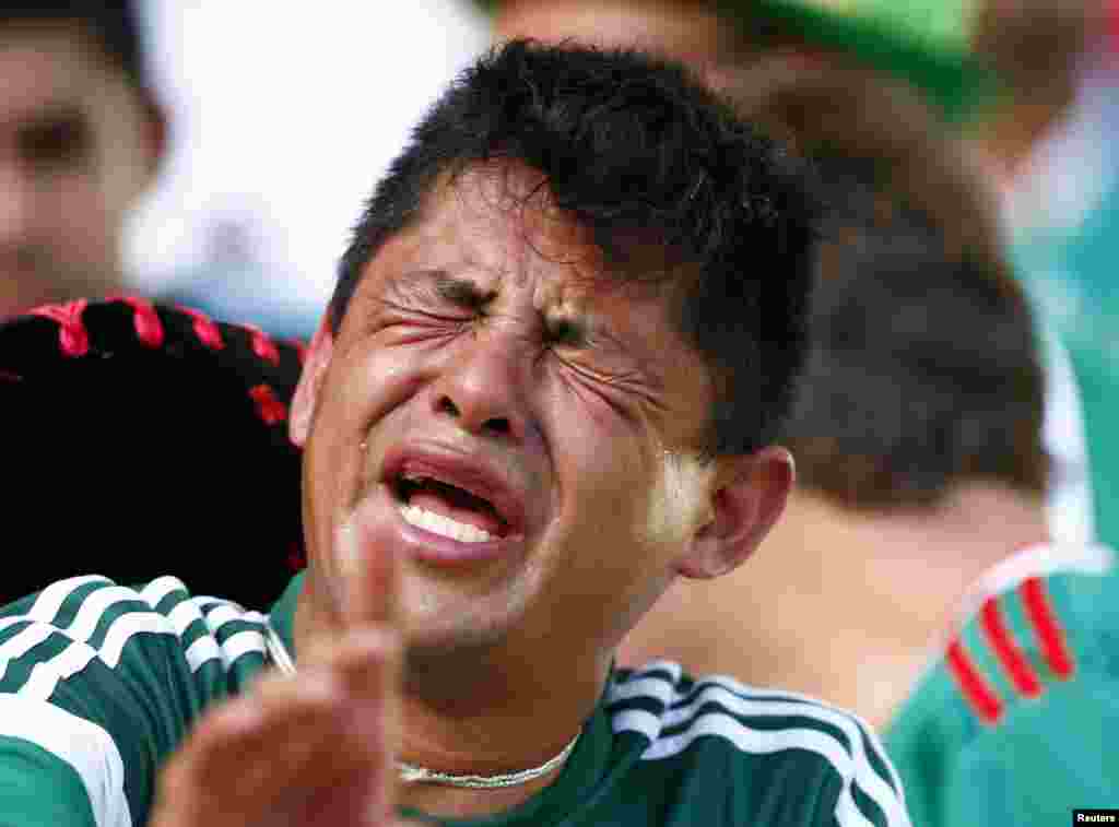 A Mexico fan reacts after his team lost to the Netherlands at the Castelao arena in Fortaleza, June 29, 2014. 