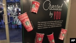 Starbucks holiday cups appear on display Nov. 8, 2016, at a store in New York. Snowflakes, reindeer and candy canes are back on Starbucks holiday coffee cups, after last year’s plain red cups caused uproar from critics who said the chain was part of a so-called war on Christmas.