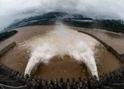 FILE -The Three Gorges Dam on the Yangtze River discharges water to lower the water level in the reservoir following heavy rainfall and floods in a few regions, in Yichang, Hubei province, China July 17, 2020. (China Daily via Reuters)