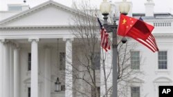 American and Chinese flags fly along Pennsylvania Avenue in front of the White House in Washington, Monday, Jan. 17, 2011. On Wednesday, Chinese President Hu Jintao arrives for a state visit. (AP Photo/Carolyn Kaster)