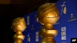 FILE - Golden Globe statues appear on stage prior to the nominations for 75th Annual Golden Globe Awards at the Beverly Hilton hotel in Beverly Hills, Calif., Dec. 11, 2017. 