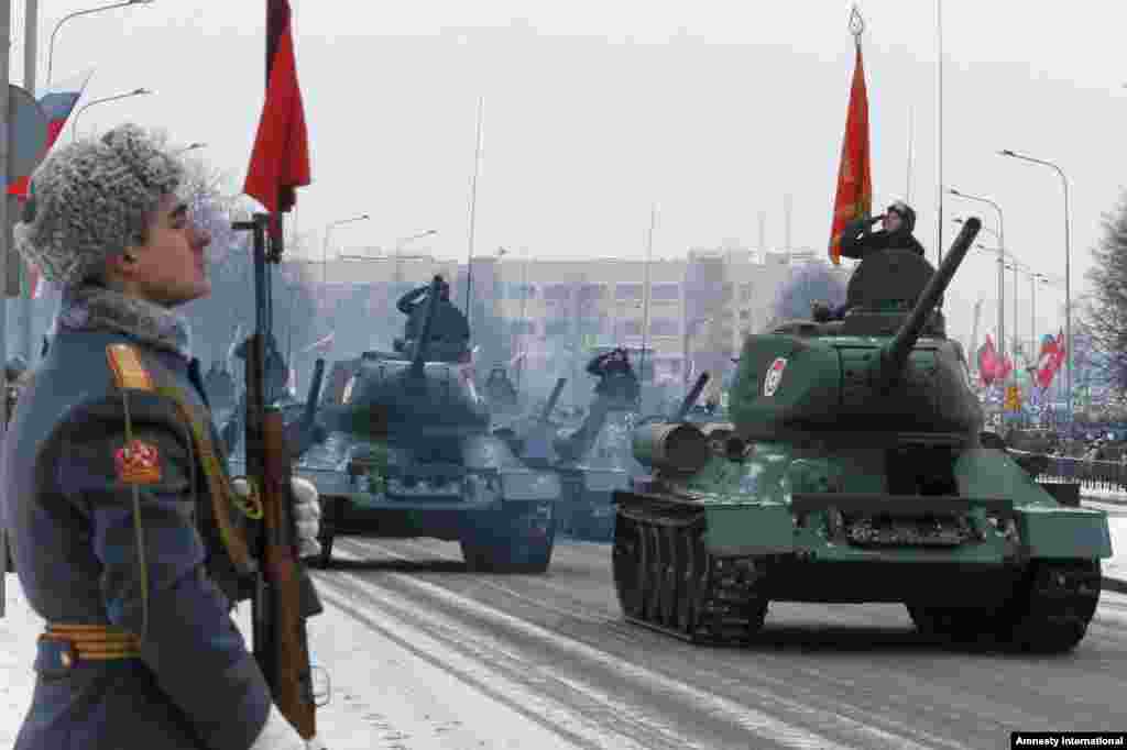 WWII-era Soviet T-34 tanks drive during a parade marking the 70th anniversary of the battle that lifted the Siege of Leningrad in St.Petersburg, Russia. More than one million people died, mainly from starvation, during the 900-day siege. 