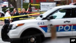 Police watch the area of an attack on campus at Ohio State Universit in Columbus, Ohio. Eleven people were injured. Police killed the attacker.