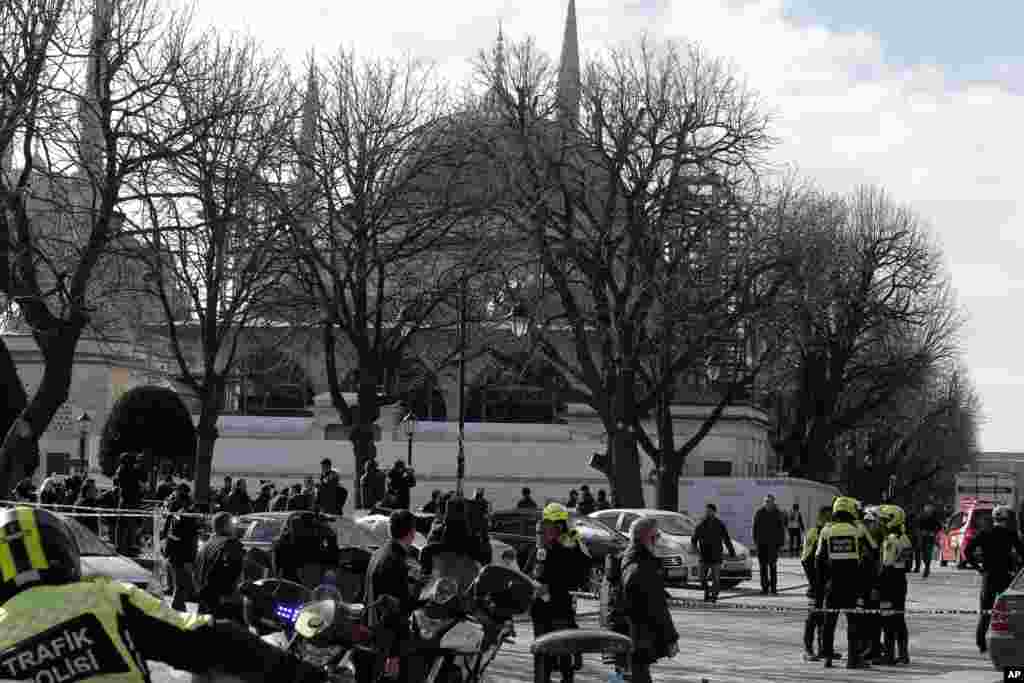 Police and media gather in front of the Blue Mosque at the historic Sultanahmet district after an explosion in Istanbul, Jan. 12, 2016.