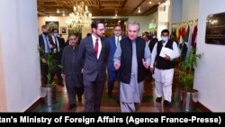 Pakistan's Foreign Minister Shah Mahmood Qureshi (R) talks with US special representative to Afghanistan, Thomas West (L), as they arrive to attend the 'Troika Plus' meeting on Afghanistan, in Islamabad.