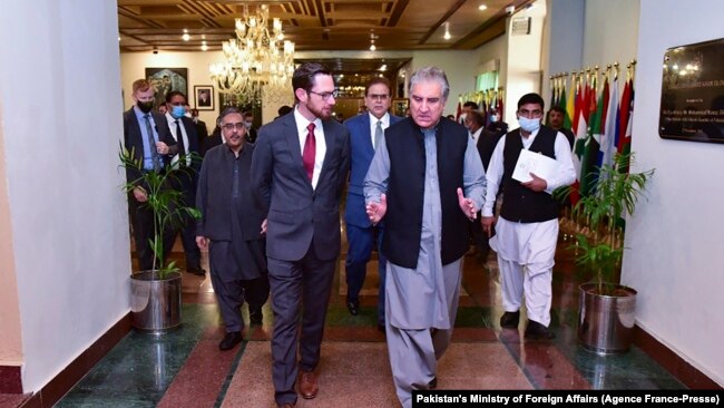 Pakistan's Foreign Minister Shah Mahmood Qureshi (R) talks with US special representative to Afghanistan, Thomas West (L), as they arrive to attend the 'Troika Plus' meeting on Afghanistan, in Islamabad.