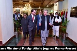 FILE - Pakistan's Foreign Minister Shah Mahmood Qureshi (R) talks with U.S. special representative to Afghanistan, Thomas West (L), as they arrive to attend the 'Troika Plus' meeting on Afghanistan, in Islamabad.