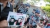 Police block protestors outside the Thai embassy in Yangon.