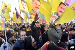 FILE - Pro-Kurdish demonstrators protest against Turkish President Recep Tayyip Erdogan and the political repression that followed July's failed military coup, in Cologne, Germany, Nov. 12, 2016.