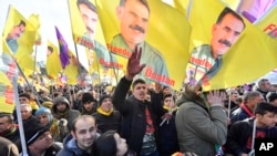 Pro-Kurdish demonstrators protest against Turkish President Recep Tayyip Erdogan and the political repression that followed July's failed military coup, in Cologne, Germany, Nov. 12, 2016.