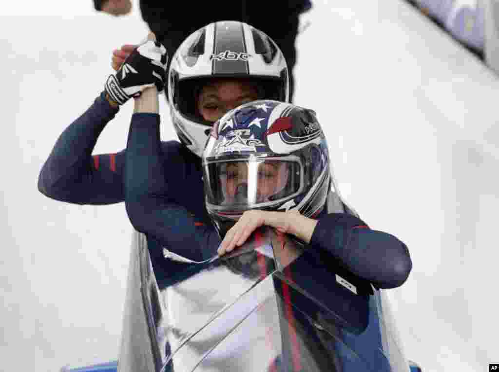 Driver Jamie Greubel Poser and brakeman Cherelle Garrett, of the United States, celebrate their win in the women&#39;s bobsled World Cup race in Lake Placid, New York.