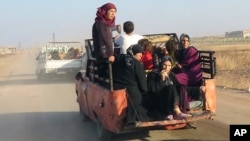 This photo provided by the Syria Press Center (SPC), an anti-government media group, shows civilians leaving the town of Suran, in Hama province, Sept. 1, 2016. 