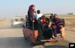 This photo provided by the Syria Press Center (SPC), an anti-government media group, shows civilians leaving the town of Suran, in Hama province, Sept. 1, 2016.