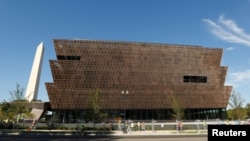 The Washington Monument rises behind the National Museum of African American History and Culture on the National Mall in Washington, Sept. 14, 2016.