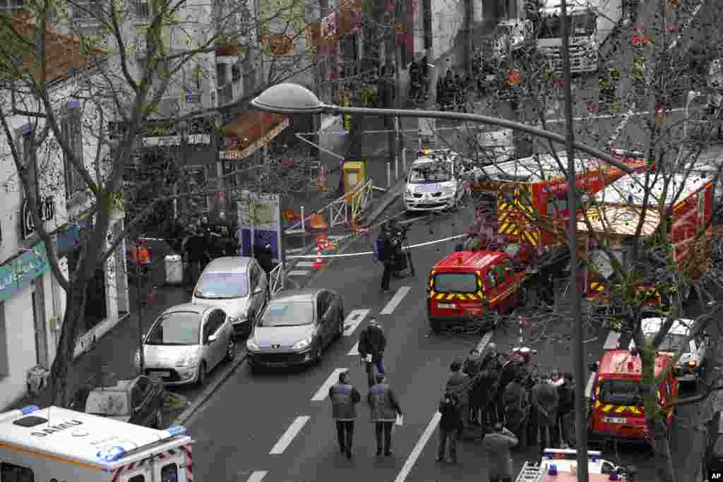 Police officers, firefighters and rescue workers gather at the site of a shooting in Montrouge, south of Paris, Jan. 8, 2015.