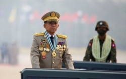 FILE - Myanmar's junta chief Senior General Min Aung Hlaing presides over an army parade on Armed Forces Day in Naypyitaw, Myanmar, March 27, 2021.
