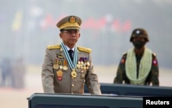 FILE - Myanmar's junta chief Senior General Min Aung Hlaing presides over an army parade on Armed Forces Day in Naypyitaw, Myanmar, March 27, 2021.