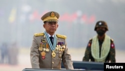 FILE - Myanmar's junta chief Senior General Min Aung Hlaing presides over an army parade on Armed Forces Day in Naypyitaw, Myanmar, March 27, 2021.