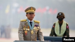 FILE - Myanmar's junta chief Senior General Min Aung Hlaing presides over an army parade on Armed Forces Day in Naypyitaw, Myanmar, March 27, 2021. 