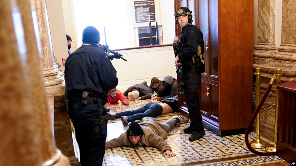 U.S. Capitol Police hold protesters at gun-point near the House Chamber inside the U.S. Capitol on Wednesday, Jan. 6, 2021, in Washington. (AP Photo/Andrew Harnik)