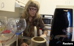 Gayle McCormick works in her kitchen in this still photo taken from video, inside her new apartment in Bellingham, Washington, Feb. 2, 2017.
