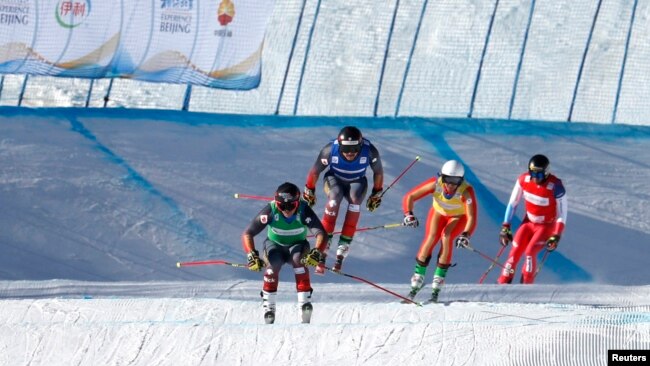 Canada's Brady Leman, Canada's Kristofor Mahler, Russia's Igor Omelin, and Switzerland's Alex Fiva in action during the men's ski cross at the FIS Ski Cross World Cup, Genting Snow Park, Zhangjiakou, China, Nov. 27, 2021. (REUTERS/Tingshu Wang)