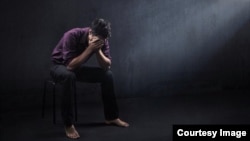 FILE - A depressed man is seen in a photo illustration.