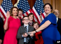 House Speaker Nancy Pelosi of Calif., administers the House oath of office to Rep. Katie Porter, D-Calif., during ceremonial swearing-in on Capitol Hill in Washington, Jan. 3, 2019, during the opening session of the 116th Congress.