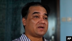 FILE - Outspoken Uighur scholar and advocate Ilham Tohti speaks during an interview at his home in Beijing.