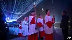 FILE - Cross-bearers lead procession into the Southern Cathedral, an officially-sanctioned Catholic church in Beijing, China, Thursday, Dec. 24, 2015. (AP Photo/Mark Schiefelbein)