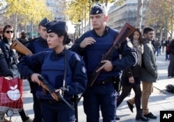 FILE - French police patrol at the Monument a la Republique, in the Place de la Republique in Paris, where people are gathering on Nov. 15, 2015, two days after a series of deadly attacks.