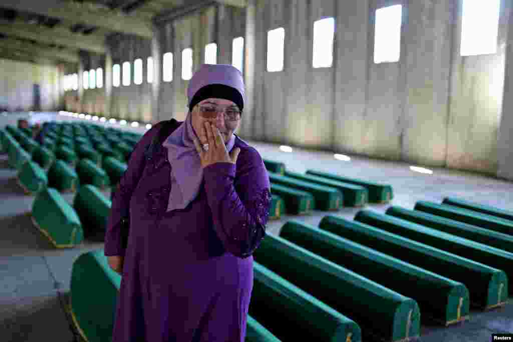 A woman cry next to coffins of her relatives who were victims of the 1995 Srebrenica massacre in Potocari, at the Bosnia and Herzegovina Memorial Center Potocari, Bosnia and Herzegovina. The bodies of 136 recently identified victims will be buried on July 11, the anniversary of the massacre.