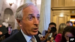 Sen. Bob Corker speaks with reporters after the immigration bill got more than 60 needed votes to advance in the Senate, at the Capitol in Washington, June 24, 2013. 