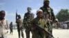 FILE - A young boy leads militant Islamist al-Shabab fighters as they conduct military exercises in northern Mogadishu's Suqaholaha neighborhood, Somalia, Jan. 1, 2010. Dozens of children kidnapped by al-Shabab and being trained as fighters were rescued from a school in the Middle Shabelle region, Somali's information minister said Friday.