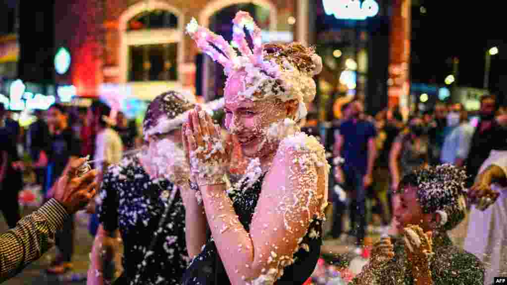 A woman is sprayed with foam as she celebrates the New Year in Kuala Lumpur, Malaysia.