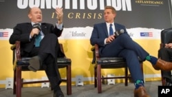 Sen. Jeff Flake, R-Ariz., right, and Sen. Chris Coons, D-Del., participate in an interview at The Atlantic's "The Constitution in Crisis" forum in Washington, Oct. 2, 2018.