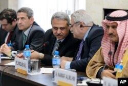 Member of the Syrian interior opposition Mahmoud Marai, third right, listens to Elian Mous'ad, second right, during a meeting with the UN Syria Envoy during Syria peace talks at the United Nations Office in Geneva, Switzerland, April 22, 2016.