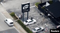 Investigators work the scene following a mass shooting at the Pulse gay nightclub in Orlando Florida, U.S., June 12, 2016.